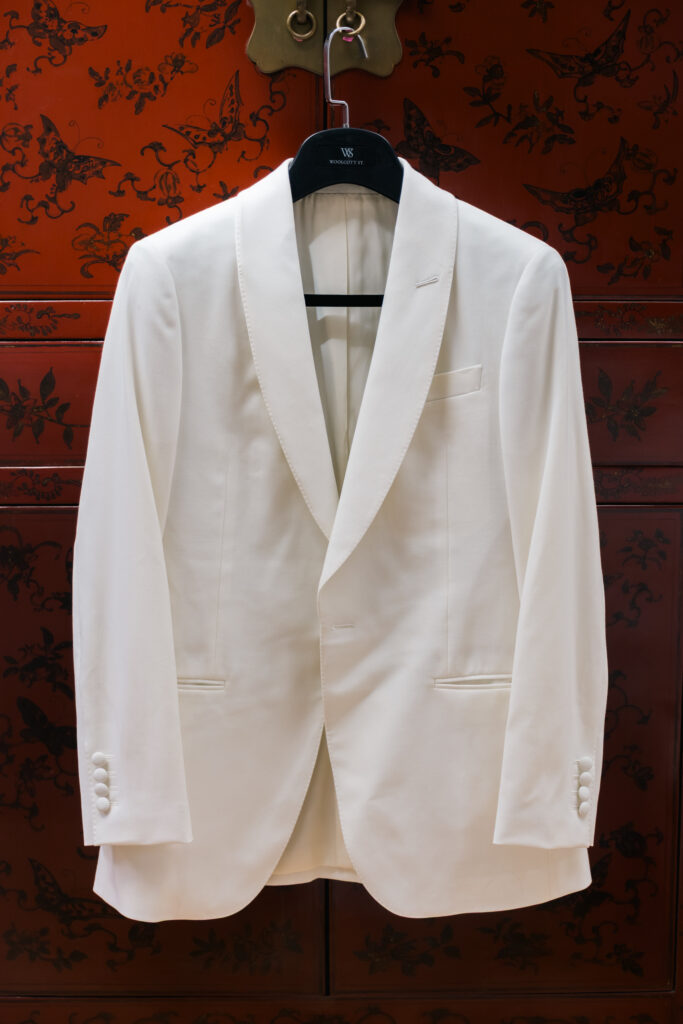 Groom's wedding jacket hanging neatly before the ceremony.