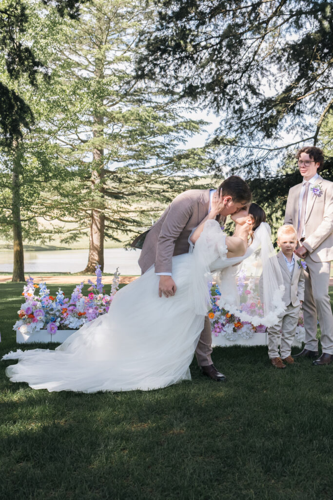 Bride and groom sharing their first kiss during their wedding ceremony at Bendooley Estate.