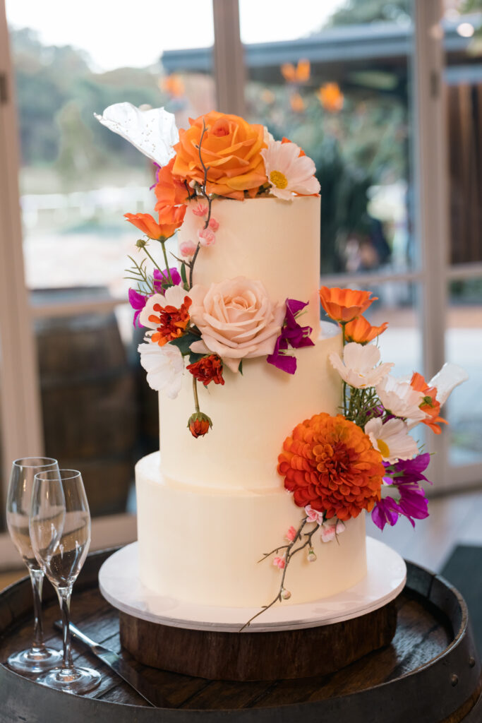 Elegant wedding cake detail with floral decorations at a wedding reception in Sydney